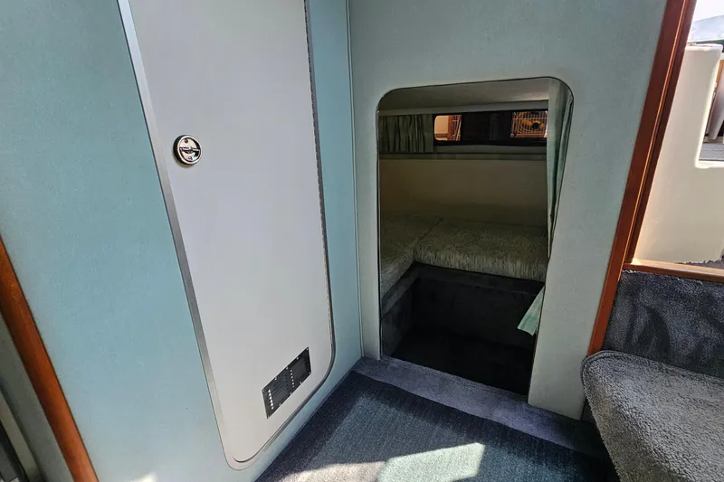 Slide: The Image of Interior cabin of 1989 Sea Ray 280 Sundancer with cozy sleeping area. - 18