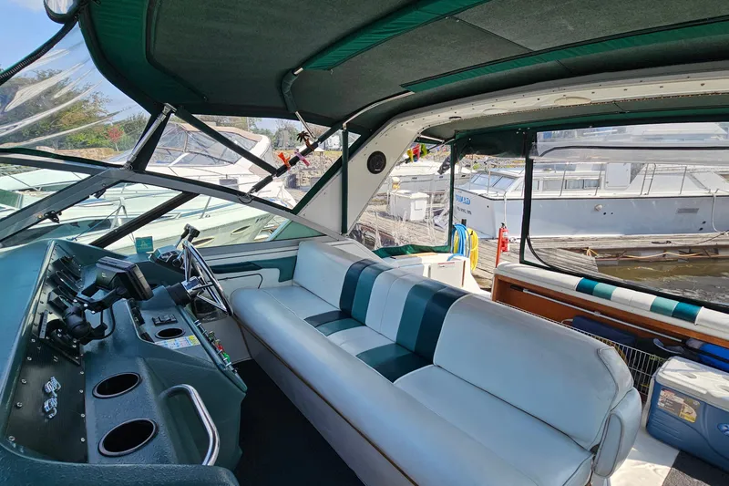 Slide: The Image of Interior view of 1989 Sea Ray 280 Sundancer boat with seating and control panel. - 9