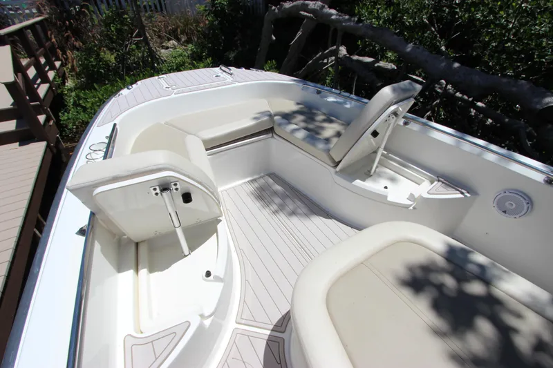 Slide: The Image of 2017 Boston Whaler 270 Dauntless boat interior with cushioned seating and storage compartments. - 29