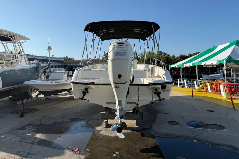 Slide: The Image of 2017 Boston Whaler 270 Dauntless boat with canopy, docked outdoors under clear sky. - 5