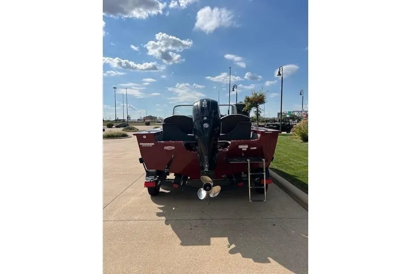 Slide: The Image of 2014 Tracker Targa V-18 Combo boat with outboard motor, parked on sunny day. - 2