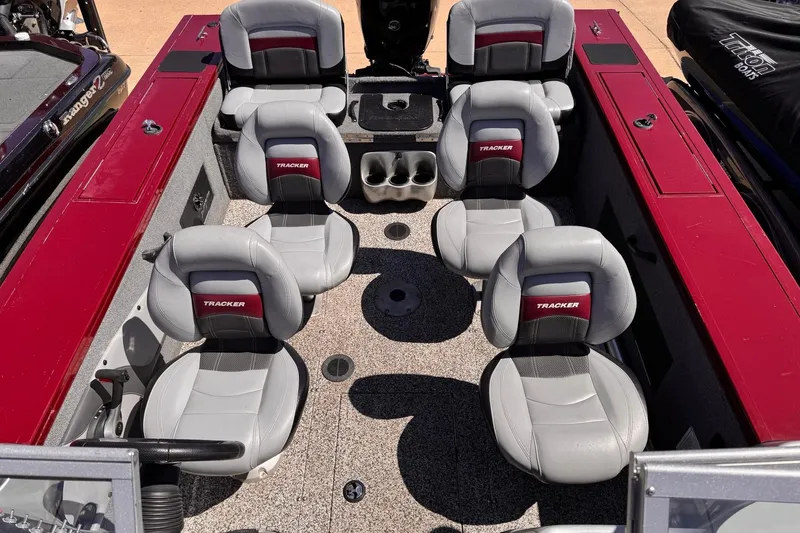 Slide: The Image of 2014 Tracker Targa V-18 Combo boat interior with six gray and red seats. - 3