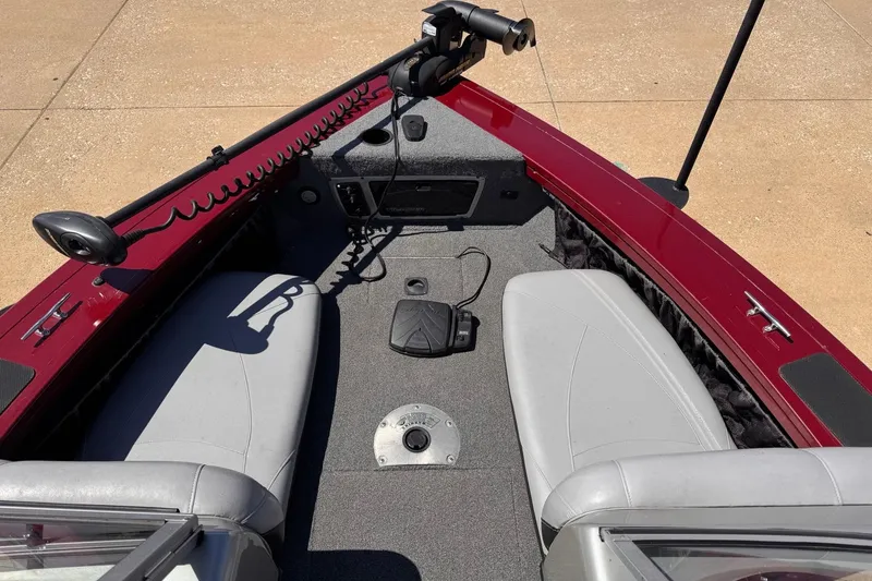 Slide: The Image of 2014 Tracker Targa V-18 Combo boat interior with gray seats and red trim. - 4