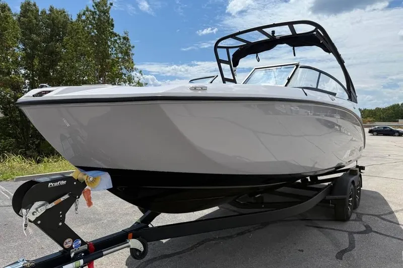 Slide: The Image of 2026 Yamaha Boats AR250 on trailer, sleek design, parked outdoors under blue sky. - 1