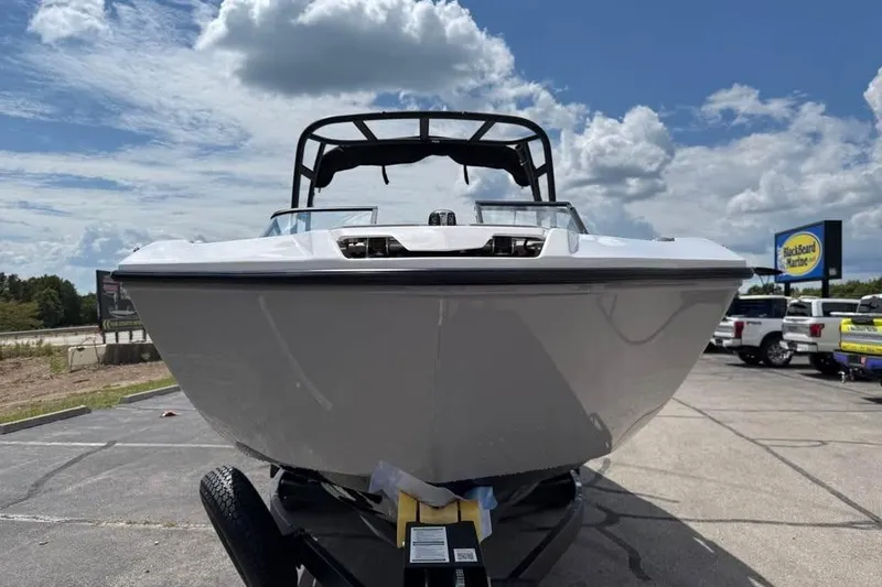 Slide: The Image of 2026 Yamaha Boats AR250 on trailer under a partly cloudy sky. - 2