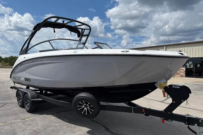 Slide: The Image of 2026 Yamaha Boats AR250 on trailer, parked outdoors under cloudy sky. - 3
