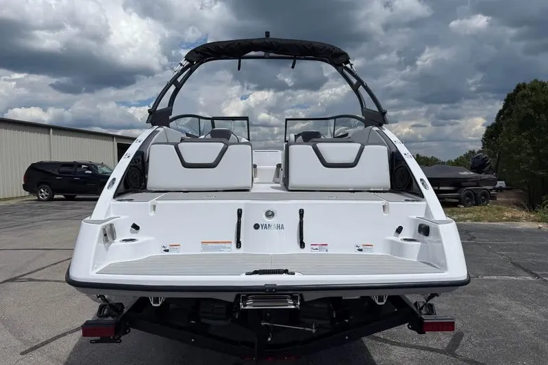 Slide: The Image of 2026 Yamaha Boats AR250, rear view, parked outdoors under cloudy sky. - 5