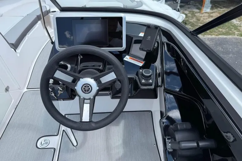 Slide: The Image of 2026 Yamaha Boats AR250 dashboard with steering wheel and touchscreen display. - 9