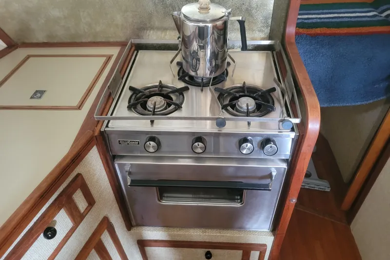 Slide: The Image of Stainless steel stove with kettle in 1981 Bayliner 3270 Explorer boat kitchen. - 17