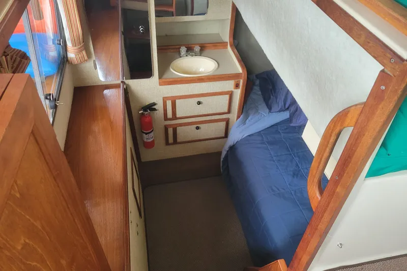 Slide: The Image of Interior cabin of 1981 Bayliner 3270 Explorer with bed, sink, and fire extinguisher. - 22