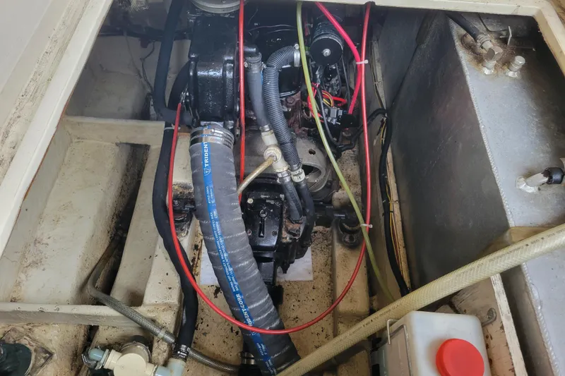 Slide: The Image of Engine compartment of a 1981 Bayliner 3270 Explorer with visible hoses and wiring. - 24