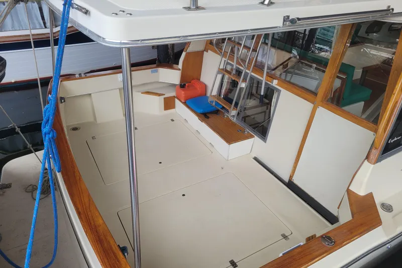 Slide: The Image of 1981 Bayliner 3270 Explorer boat deck with seating and storage compartments. - 3