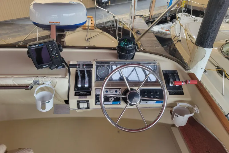 Slide: The Image of 1981 Bayliner 3270 Explorer helm with steering wheel, controls, and navigation equipment. - 8