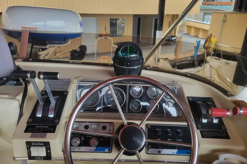 Slide: The Image of Cockpit of 1981 Bayliner 3270 Explorer with steering wheel and control panel. - 9