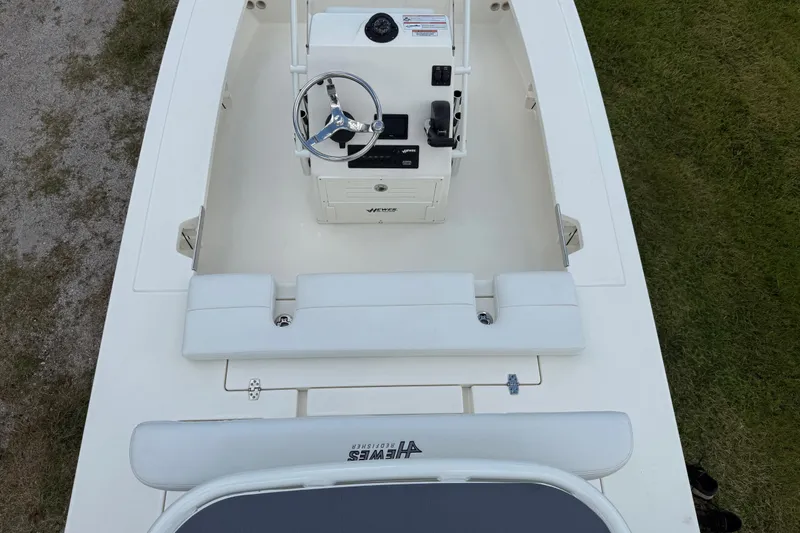 Slide: The Image of 2026 Hewes 16 Redfisher boat interior with steering console and seating. - 13