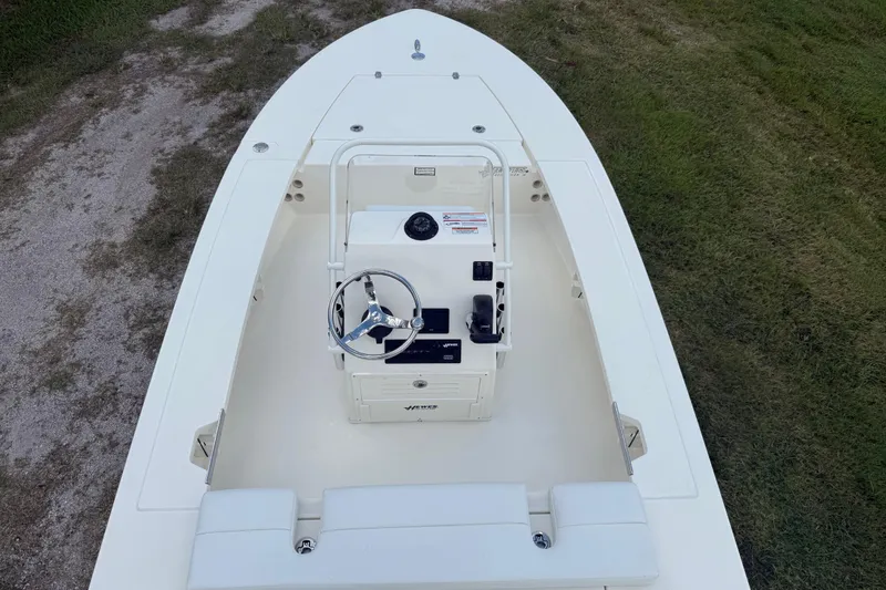 Slide: The Image of 2026 Hewes 16 Redfisher boat, top view, showcasing steering console and seating. - 14