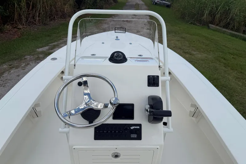 Slide: The Image of 2026 Hewes 16 Redfisher boat console with steering wheel and controls. - 15