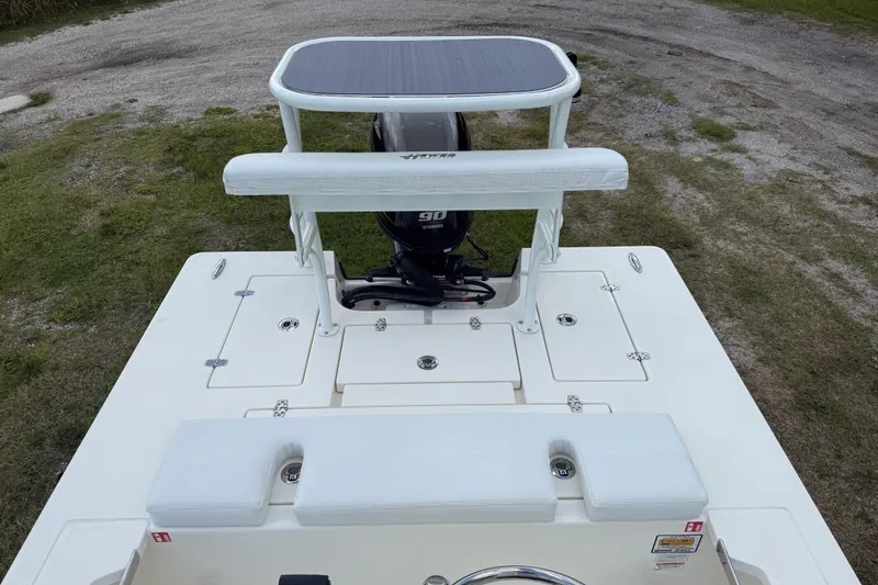 Slide: The Image of 2026 Hewes 16 Redfisher boat with Yamaha 90 engine, viewed from above on grassy terrain. - 21