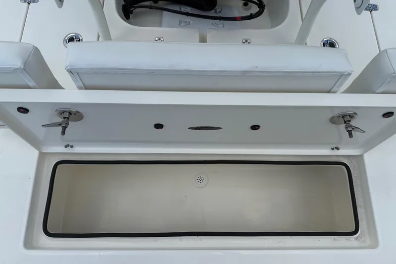 Slide: The Image of 2026 Hewes 16 Redfisher boat storage compartment with open lid, showcasing interior space. - 23