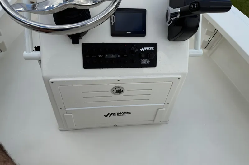 Slide: The Image of 2026 Hewes 16 Redfisher boat console with steering wheel and controls. - 28