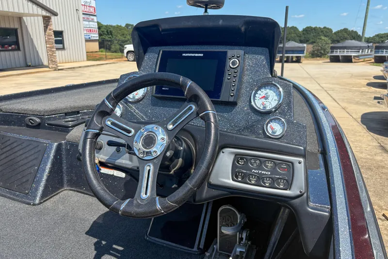 Slide: The Image of 2021 Nitro Z19 boat dashboard with steering wheel, gauges, and control panel. - 13