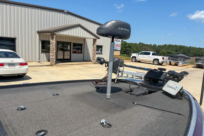 Slide: The Image of 2021 Nitro Z19 boat with Garmin equipment, parked outside a metal building on a sunny day. - 3