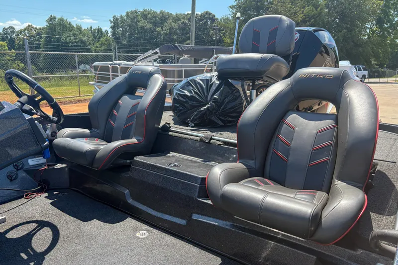 Slide: The Image of 2021 Nitro Z19 boat interior with black and red seats, steering wheel, and console. - 4