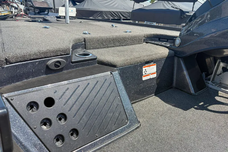 Slide: The Image of Interior of a 2021 Nitro Z19 boat, featuring carpeted deck and storage compartments. - 7