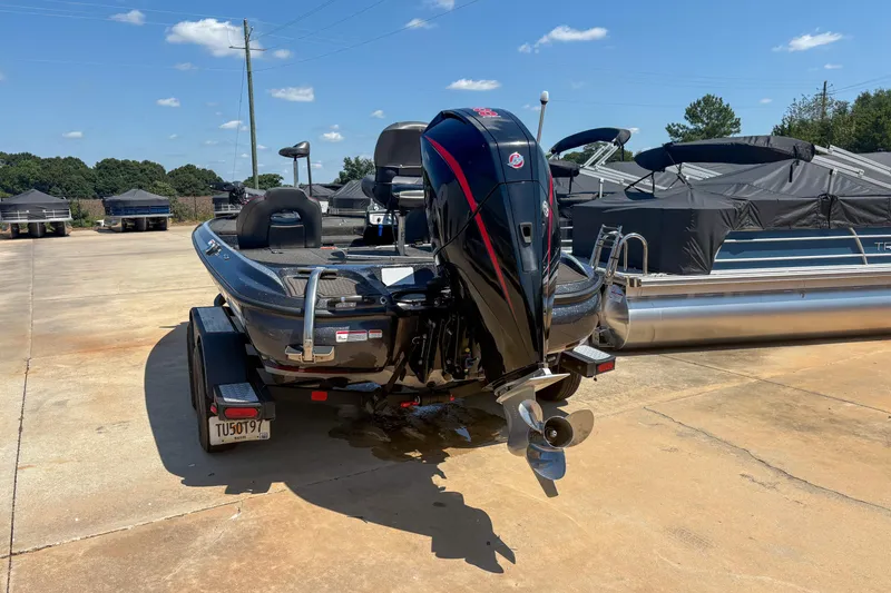 Slide: The Image of 2021 Nitro Z19 boat with outboard motor in a sunny marina setting. - 9