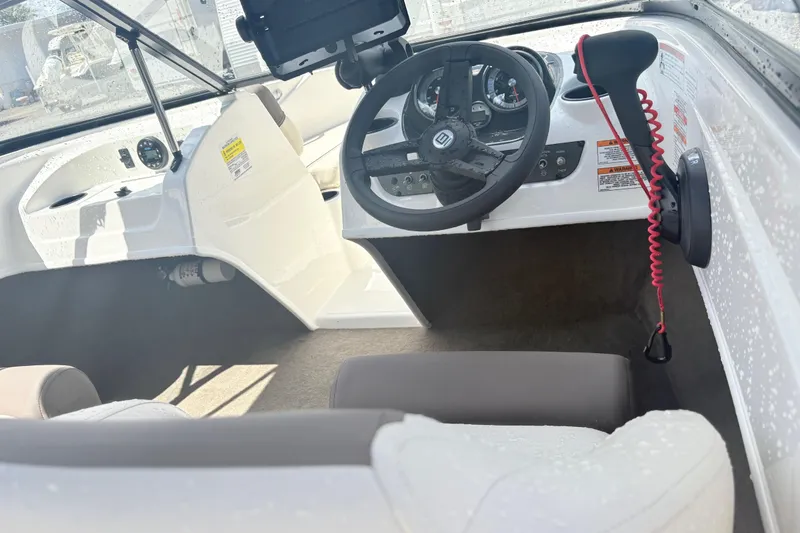 Slide: The Image of 2020 Bayliner 170 Bowrider interior with steering wheel and dashboard controls. - 10