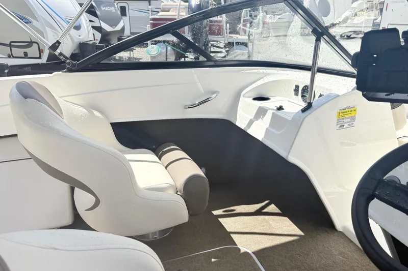 Slide: The Image of 2020 Bayliner 170 Bowrider interior with white seating and steering wheel. - 12