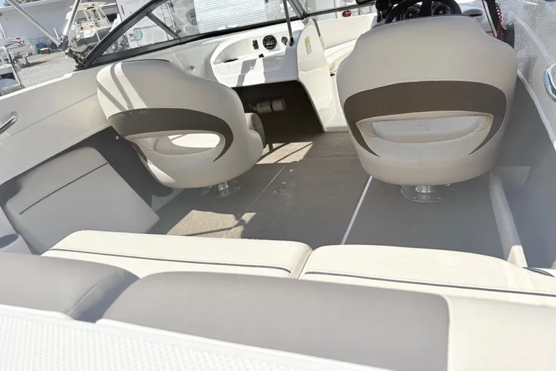 Slide: The Image of Interior of a 2020 Bayliner 170 Bowrider boat with beige seating and steering console. - 15