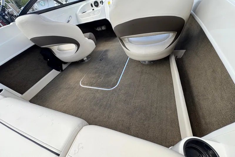 Slide: The Image of Interior of a 2020 Bayliner 170 Bowrider boat, featuring beige seating and carpeted flooring. - 22