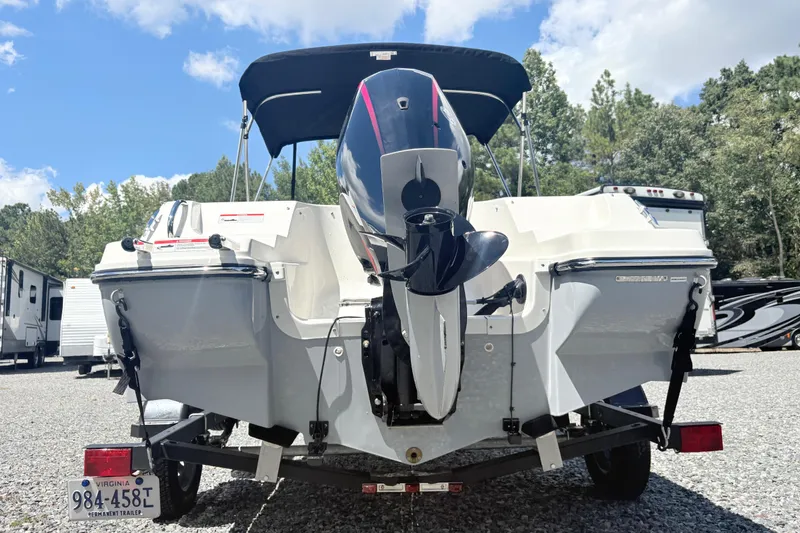 Slide: The Image of 2020 Bayliner 170 Bowrider boat with outboard motor, parked on a trailer. - 5