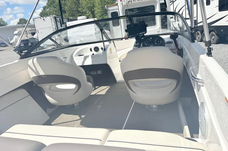 Slide: The Image of 2020 Bayliner 170 Bowrider interior with seating and dashboard, parked outdoors. - 7