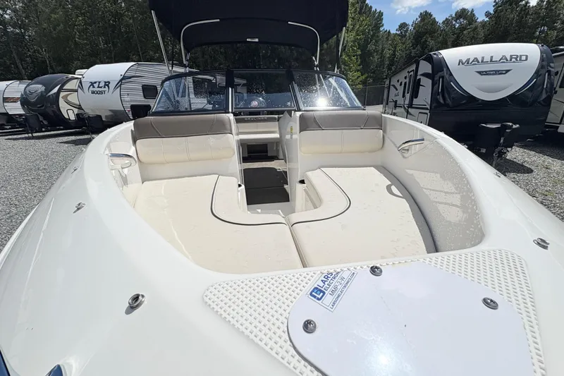 Slide: The Image of 2020 Bayliner 170 Bowrider boat with spacious seating, parked among RVs. - 9