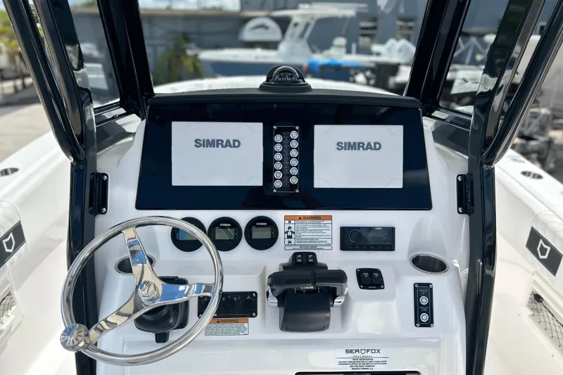 Slide: The Image of 2026 Sea Fox 268 Commander dashboard with Simrad displays and steering wheel. - 18