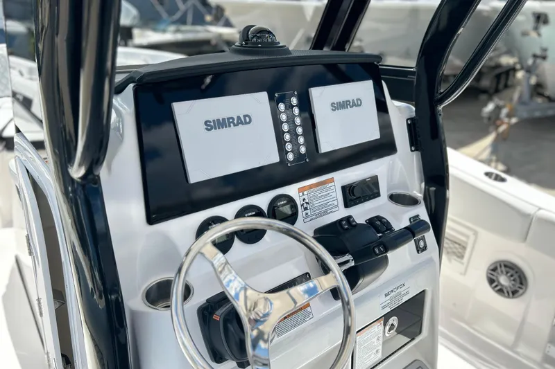 Slide: The Image of 2026 Sea Fox 268 Commander boat dashboard with Simrad navigation system. - 19