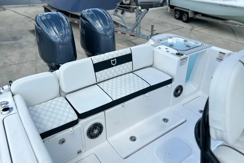 Slide: The Image of 2026 Sea Fox 268 Commander boat interior with cushioned seating and dual outboard motors. - 28