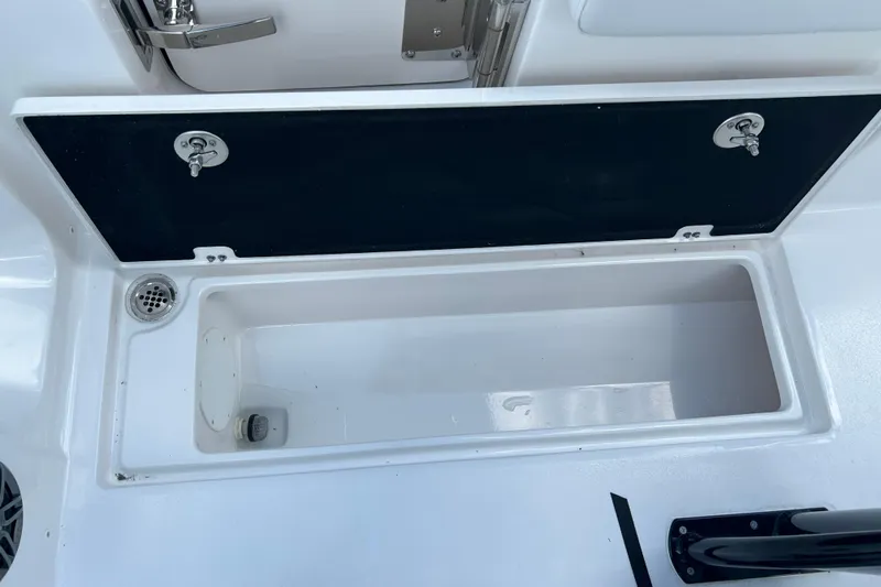 Slide: The Image of Storage compartment on 2026 Sea Fox 268 Commander boat, featuring secure latches and drainage. - 32