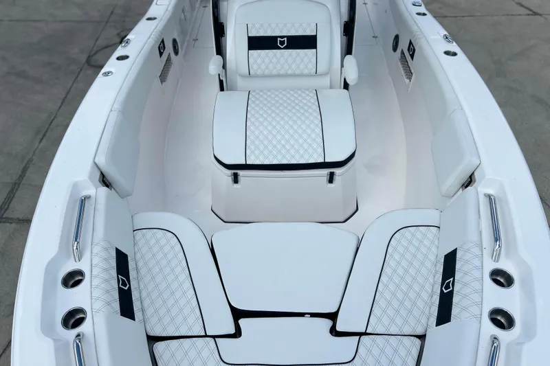 Slide: The Image of 2026 Sea Fox 268 Commander boat interior with white cushioned seating and sleek design. - 6
