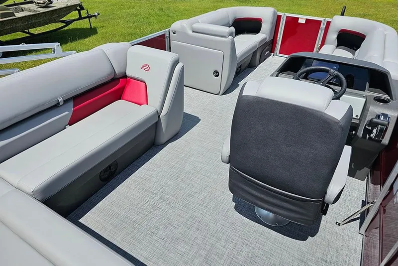 Slide: The Image of 2026 Sun Tracker Party Barge 20 DLX interior with plush seating and modern helm. - 10