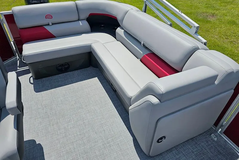 Slide: The Image of 2026 Sun Tracker Party Barge 20 DLX with luxurious gray and red seating on deck. - 12