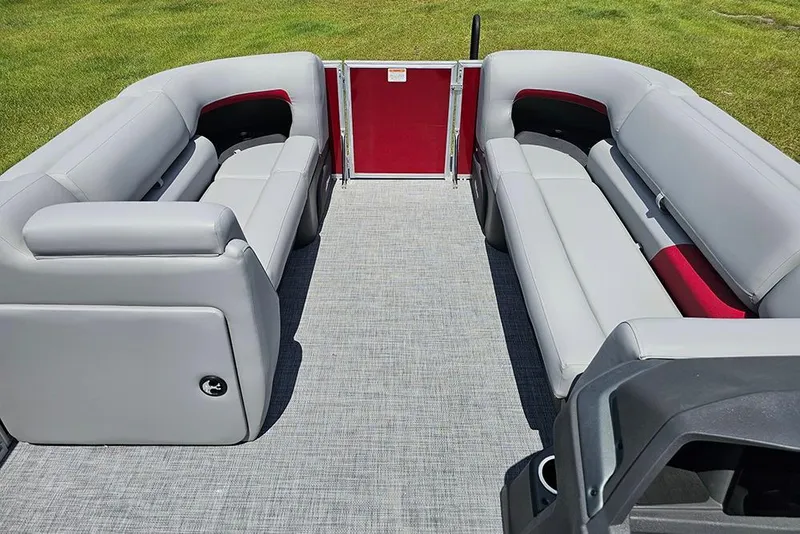 Slide: The Image of 2026 Sun Tracker Party Barge 20 DLX interior with gray seating and red accents. - 20