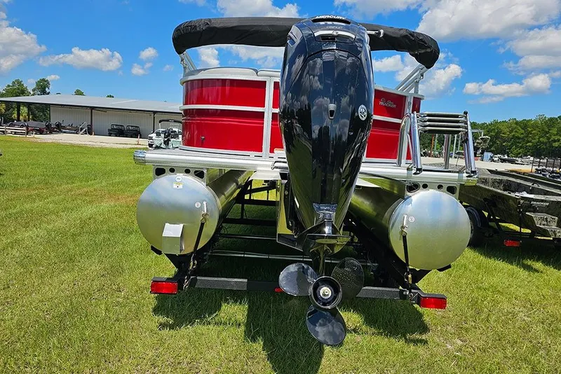 Slide: The Image of 2026 Sun Tracker Party Barge 20 DLX pontoon boat with outboard motor on grassy field. - 9