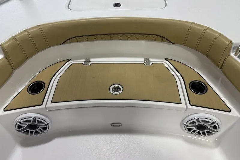 Slide: The Image of 2025 Sportsman Masters 267OE Bay Boat interior with tan seating and cup holders. - 11