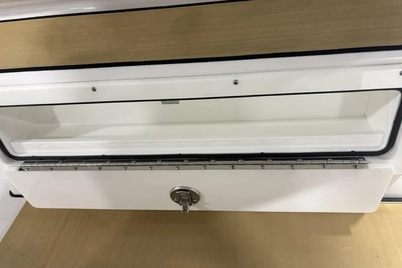 Slide: The Image of 2025 Sportsman Masters 267OE Bay Boat storage compartment with secure latch and sleek design. - 14