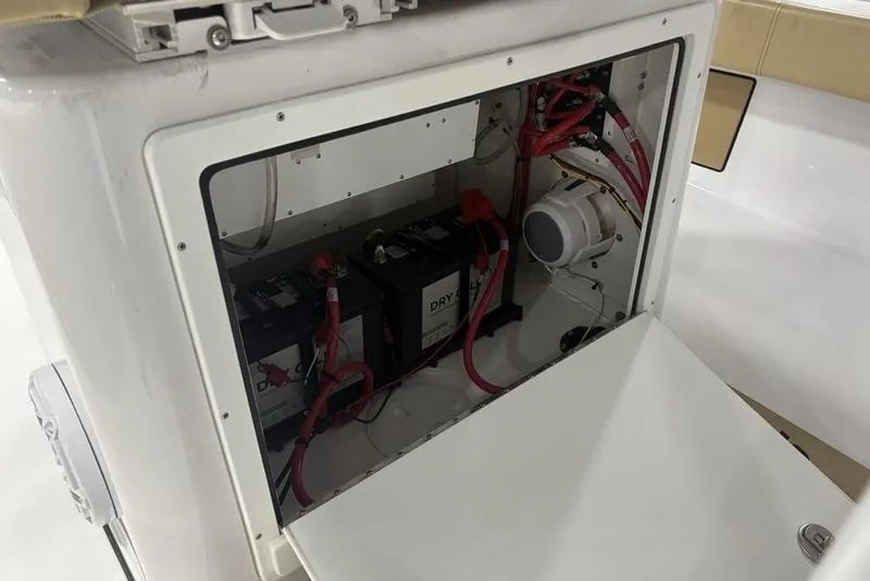 Slide: The Image of 2025 Sportsman Masters 267OE Bay Boat battery compartment with wiring and components. - 19