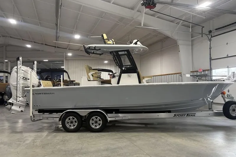 The Image of 2025 Sportsman Masters 267OE Bay Boat on trailer in indoor showroom. - 2