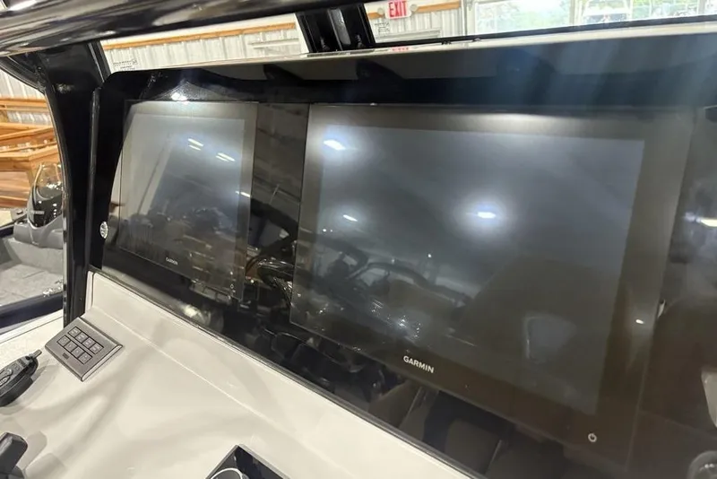 Slide: The Image of Dual Garmin displays on 2025 Sportsman Masters 267OE Bay Boat dashboard. - 20